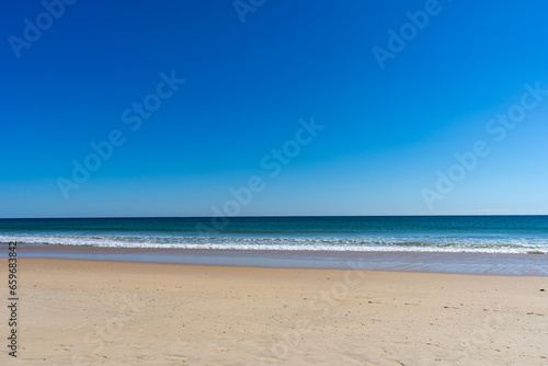 Fototapeta Naklejka Na Ścianę i Meble -  View of idyllic nature landscape with huge beaches and waves crashing on. Manta Rota beach. West Atlantic coast of Algarve region, south of Portugal.
