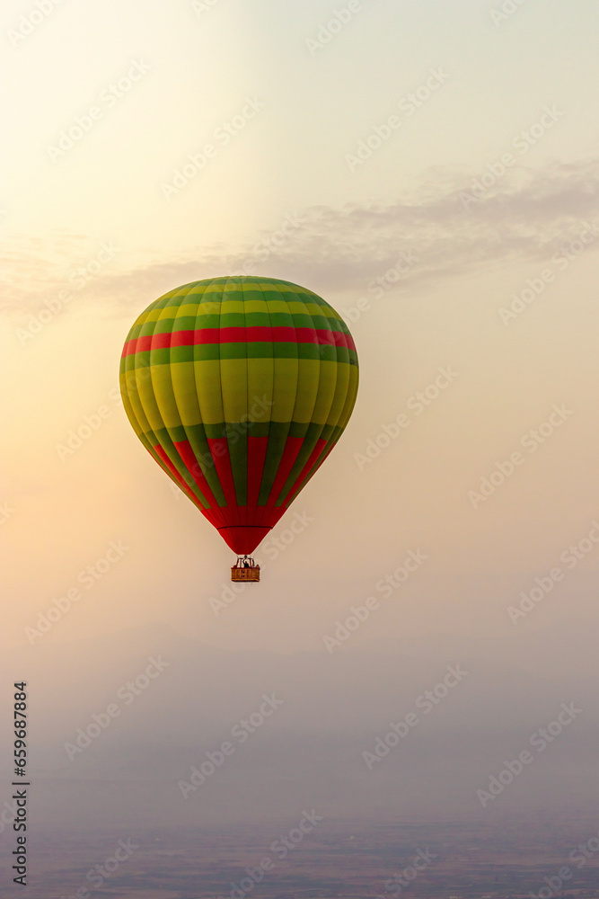 Obraz premium Hot balloon flying at sunset over the Atlas Mountains in the desert of Morocco 