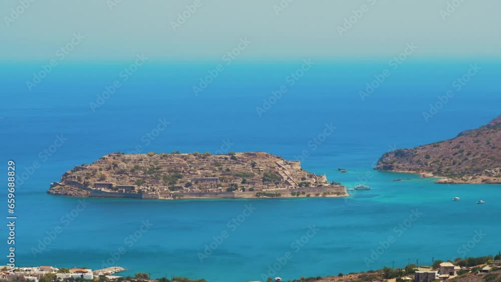 Panoramic view of sea and ancient buildings against sky,Spinalonga,Greece. High quality 4k footage Panoramic view of sea and ancient buildings against sky,Spinalonga,Greece. High quality 4k footage