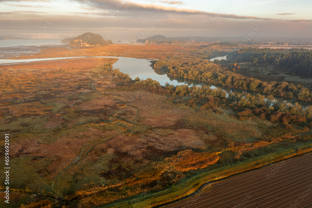 Fototapeta premium Aerial view of the Skagit Bay Estuary. The Skagit Headquarters Unit is tidal marsh (estuary) on Fir Island, west of and adjacent to Freshwater Slough.