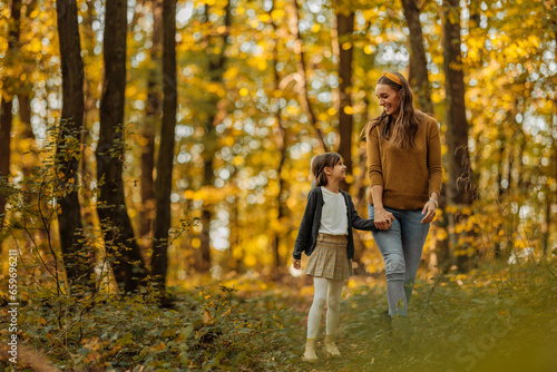 Mother and daughter exploring the forest during autumn © bernardbodo