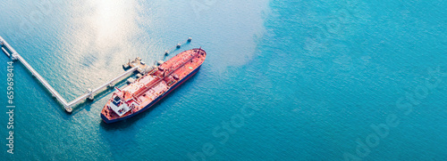 Aerial view of modern sea harbor with transshipment equipment for oil tanker ship, gas offshore platforms, Business transportation import export oil at gas petrochemical industrial factory