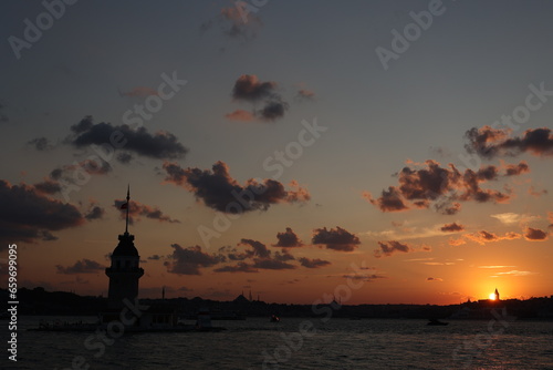 Fiery sunset over the Bosphorus with the famous Maiden's Tower (Kiz Kulesi) also known as the Leander Tower, the symbol of Istanbul, Turkey. Great travel background for wallpaper or guidebook