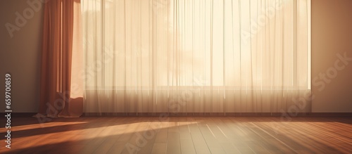 Soft sunlight filters through the fabric blinds casting a warm and comforting shadow on the floor of an empty room The evening sunshine brings forth a feeling of relaxation reminiscent of ho