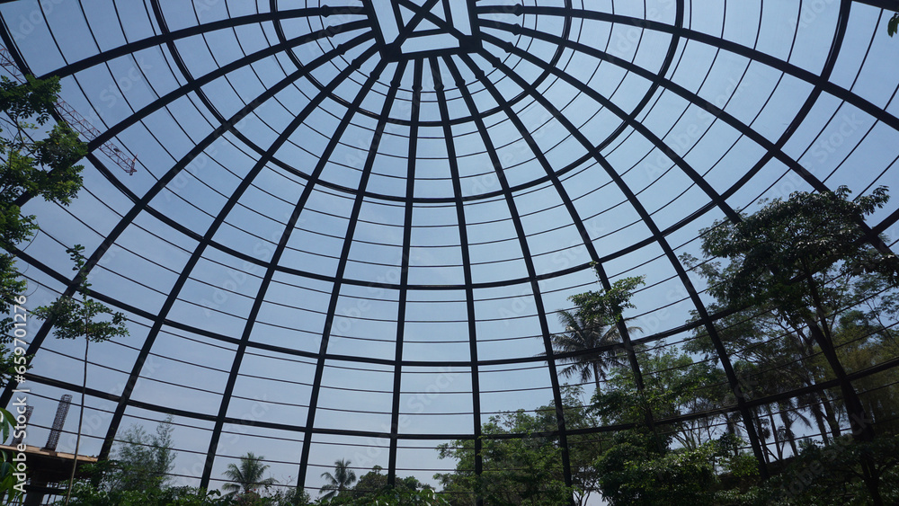 view inside a large aviary dome with curved steel in the form of dome