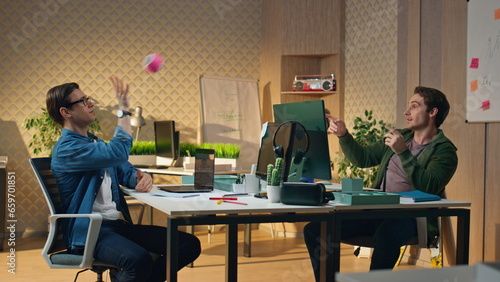 Fotografie Positive guys playing ball communicating sunny office