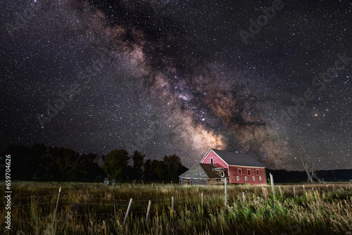 Milkyway galaxy leading down to old red barn in rural Gunnison County, Colorado