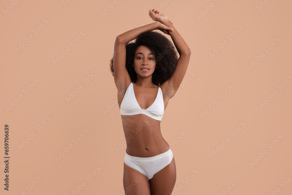 Obraz premium Beautiful woman in stylish bikini on beige background