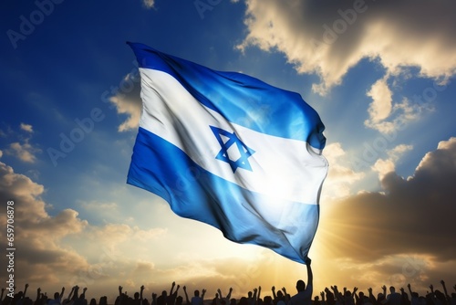 Israeli flag over a crowd of people. Patriotism concept. Background with selective focus and copy space © top images