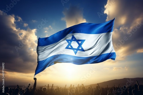 Israeli flag over a crowd of people. Independence concept. Background with selective focus and copy space photo