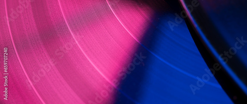 multicolored abstract music show party dj background with vinyl disc.close-up of vinyl record in blue and purple glow for background,banner.