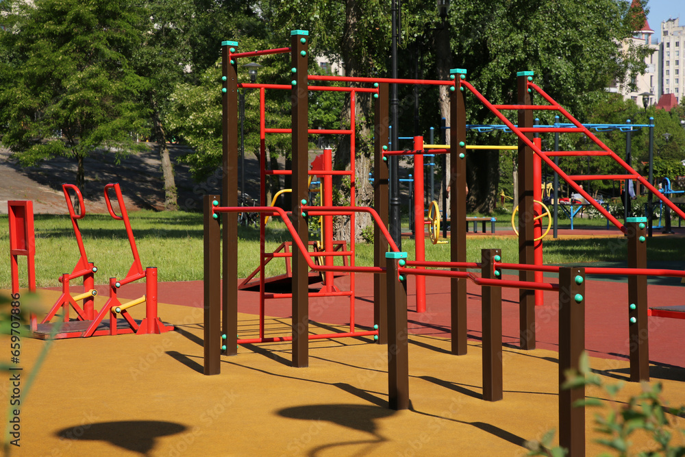Empty outdoor gym with exercise equipment in park Empty outdoor gym with exercise equipment in park