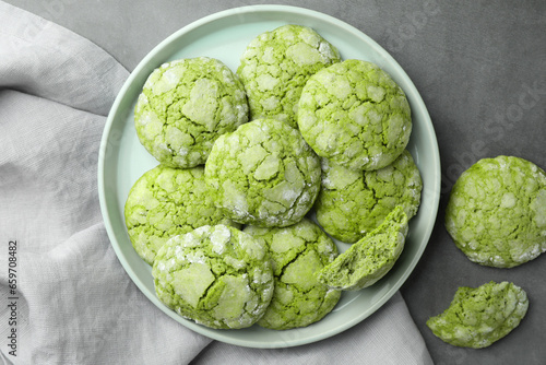 Plate with tasty matcha cookies on grey table, flat lay