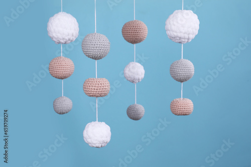 Cute baby crib mobile on light blue background