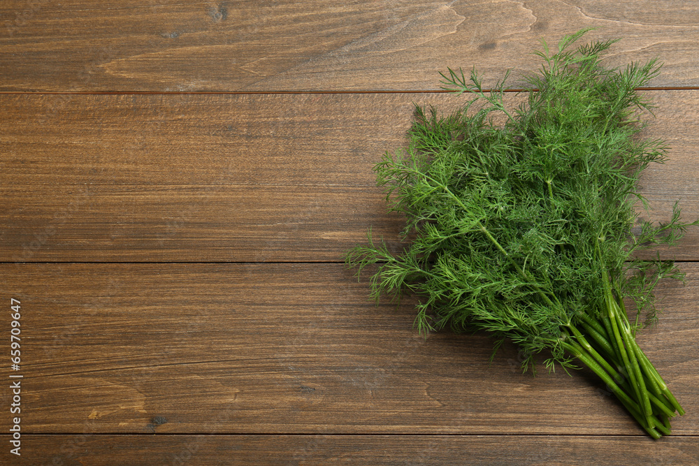 Fresh green dill on wooden table, top view. Space for text Fresh green dill on wooden table, top view. Space for text