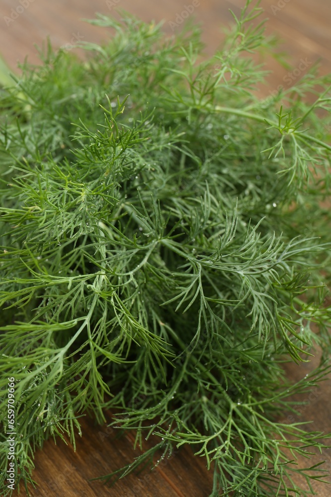Fresh green dill on wooden table, closeup