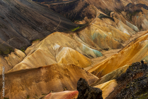 Multicolored mountains seen in Landmannalaugar, a location in Iceland's Fjallabak Nature Reserve in the Highlands, an area known for its natural geothermal hot springs and surrounding landscape. photo