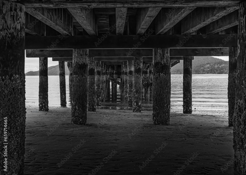 2020-08-31 UNDERNEATH A PIER ON LUMI ISLAND WITH A CALM PUGET SUND ANDA SLIGHT FOG ROLLING IN IN WASHINGTON STATE