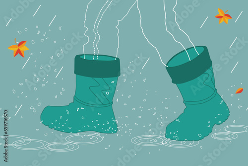 A boy in green rubber boots walking in puddles in the rain.