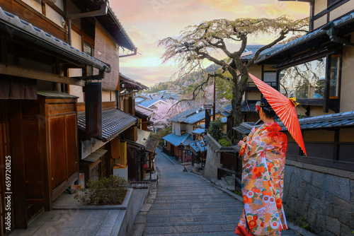 Kyoto, Japan - March 30 2023: Nineizaka or Ninenzaka s an ancient 150m stone-paved pedestrian road. The road is lined with traditional buildings and shops photo