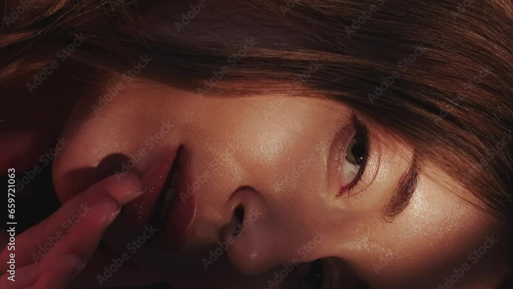 Vertical video. Facial skincare. Model posing. Woman elegance. Sensual gentle beautiful lady enjoying sunlight shadow hands touching perfect fresh flawless face skin.