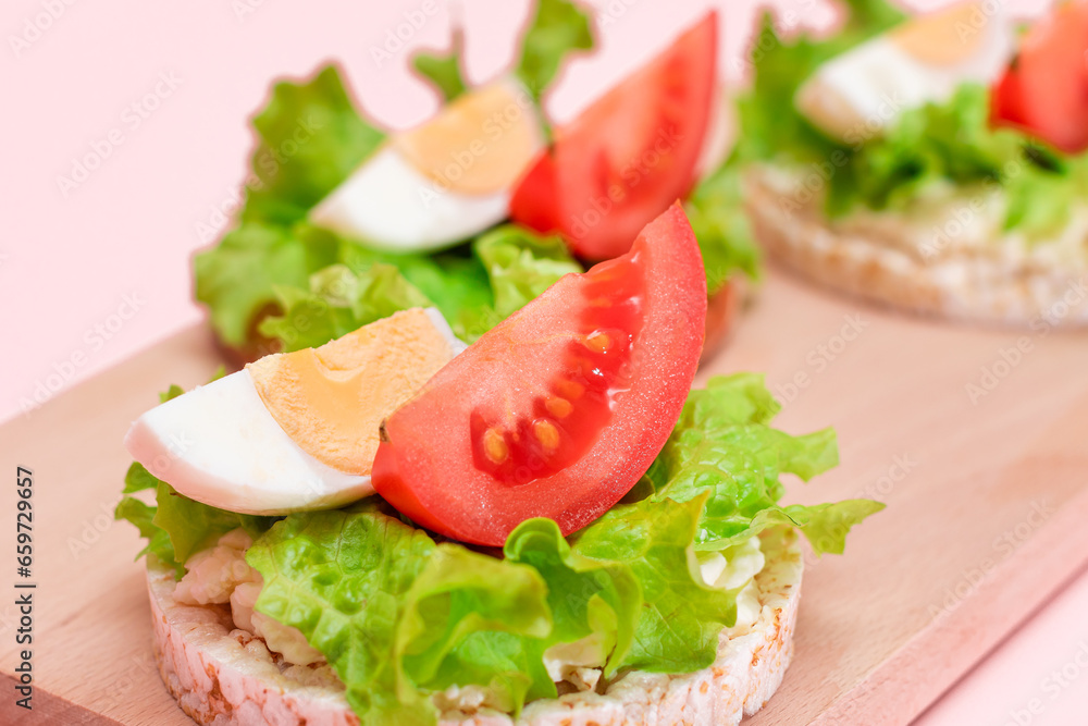 Rice Cake Sandwiches with Tomato, Lettuce and Egg on Wooden Cutting Board. Easy Breakfast. Diet Food. Quick and Healthy Sandwiches. Crispbread with Tasty Filling. Healthy Dietary Snack Rice Cake Sandwiches with Tomato, Lettuce and Egg on Wooden Cutting Board. Easy Breakfast. Diet Food. Quick and Healthy Sandwiches. Crispbread with Tasty Filling. Healthy Dietary Snack