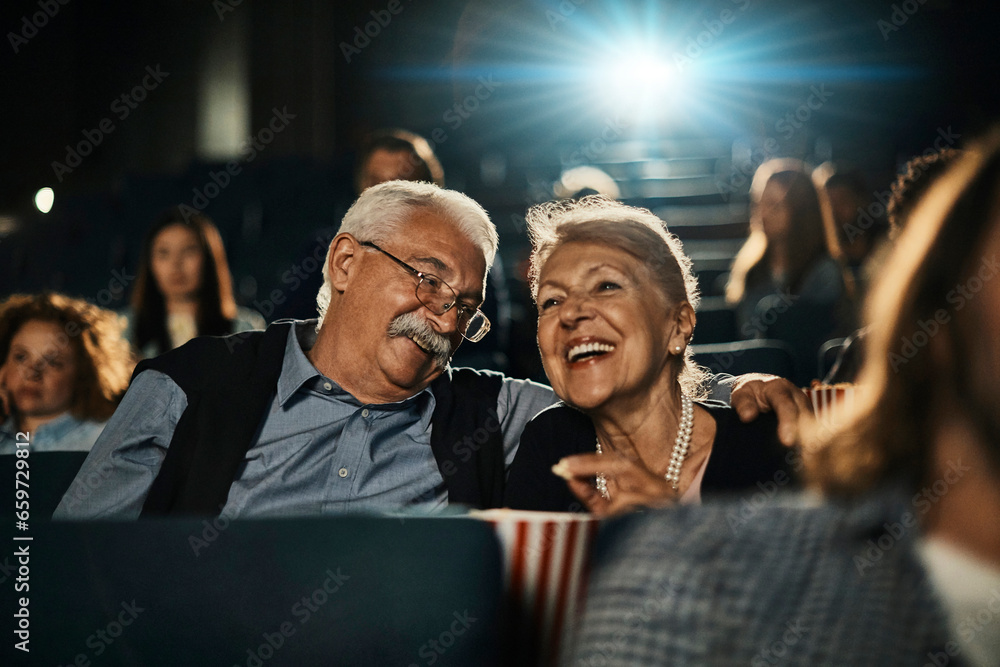 Senior Caucasian couple watching a movie in the movie theater Senior Caucasian couple watching a movie in the movie theater
