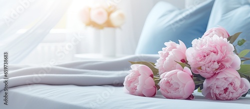 Fototapeta Naklejka Na Ścianę i Meble -  Modern design bedroom with a cozy interior including pink and blue colors and a bouquet of peonies