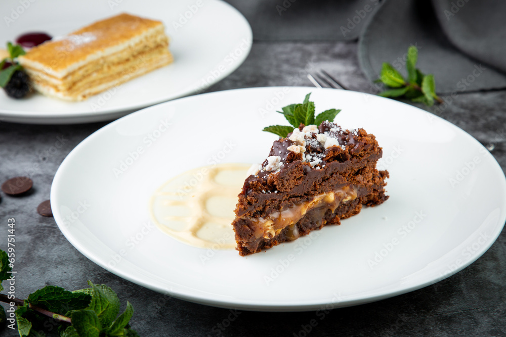 gluten free chocolate cake with nuts, berries and mint on a white plate gluten free chocolate cake with nuts, berries and mint on a white plate