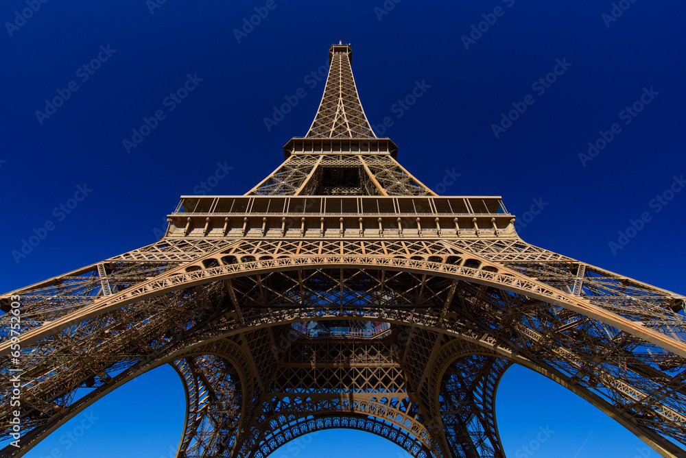 Fototapeta premium Eiffel Tower with sunny blue sky in Paris, France