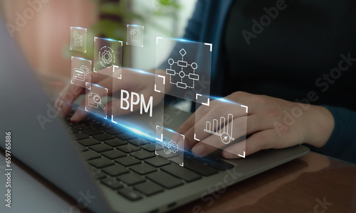BPM Business Process Management concept. The tool for businesses to optimize operations, streamline processes, improve efficiency, and reduce costs. Working on computer with BPM icons.