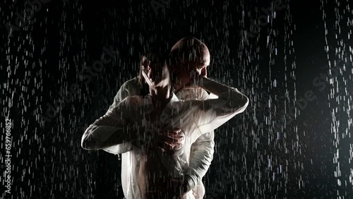 excited man and woman embracing in rain in darkness, sexy lady and her boyfriend having sex photo