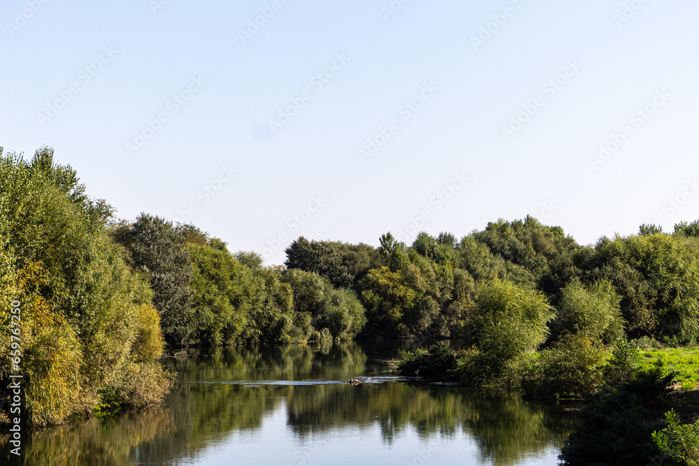 Landscape with river, trees and blue sky Landscape with river, trees and blue sky