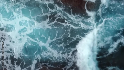 Wallpaper Mural Bird's eye view of powerful waves crashing on rocky coastline, tracking shot. vertical format Torontodigital.ca