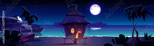 Small house with straw roof and light from window and door on sandy sea or ocean beach at night. Cartoon vector landscape of midnight dark coast with palm trees and rocks in water under moonlight.