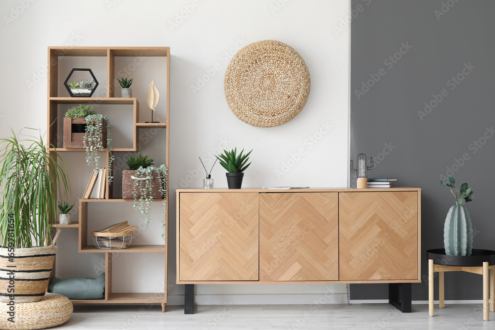 Wooden cabinet and shelving unit in interior of stylish room - obrazy, fototapety, plakaty 