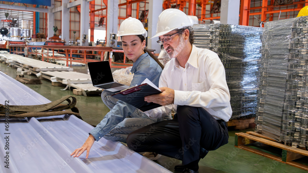 Metalwork manufacturing factory manager inspect newly manufactured metal or steel sheets and frame in factory. Inspection and quality control process ensure highest quality. Panorama Exemplifying