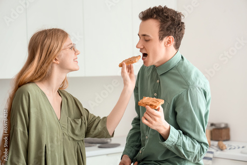 Young woman feeding her boy...