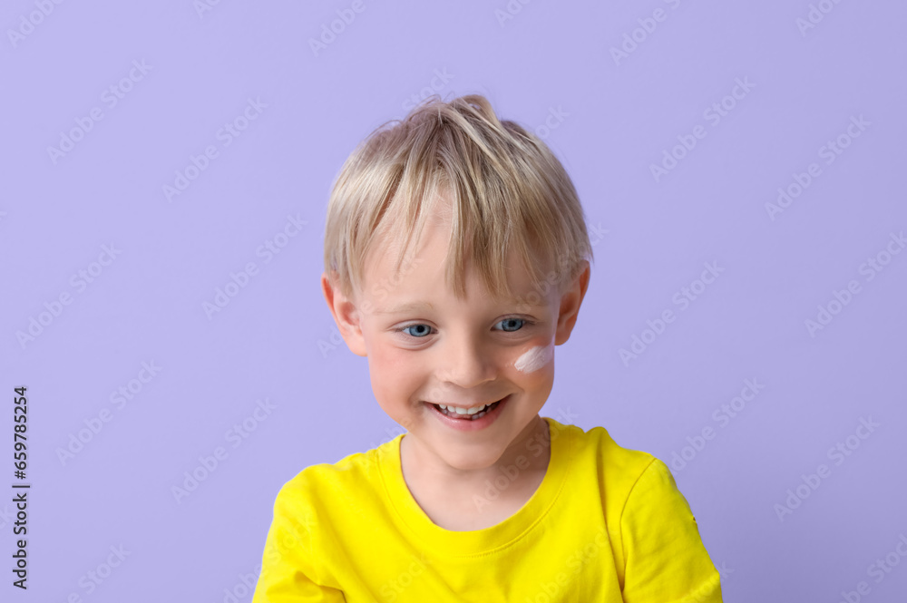 Allergic little boy with sunburned face and cream on lilac background, closeup Allergic little boy with sunburned face and cream on lilac background, closeup