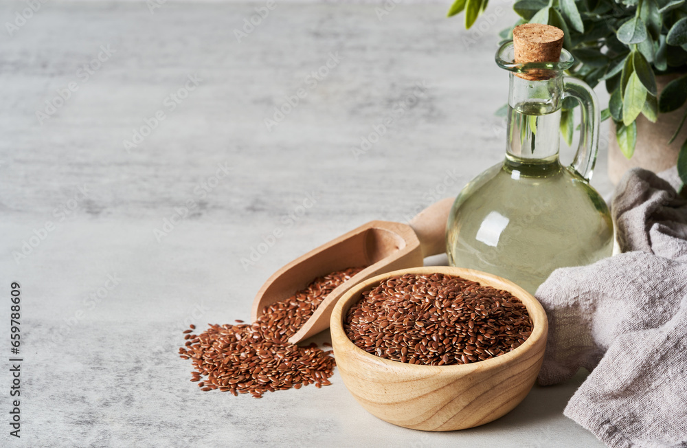 flaxseed linseed oil in wood bowl on white table background. flaxseed