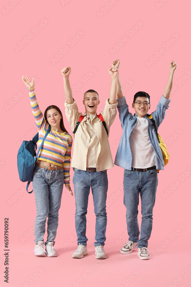 Happy students with backpacks on pink background Happy students with backpacks on pink background