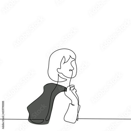 woman standing sideways and turned towards the viewer holding a jacket behind her back - one line art vector. concept turn around, leave, pass by, passerby