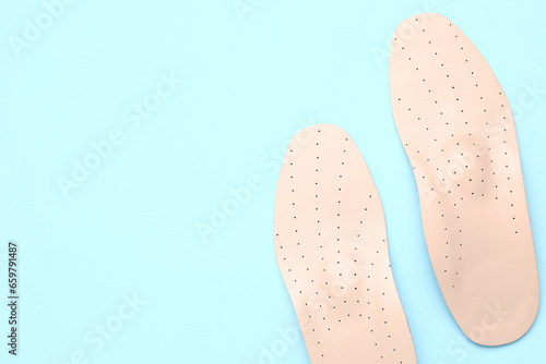 Leather orthopedic insoles on color background © Pixel-Shot