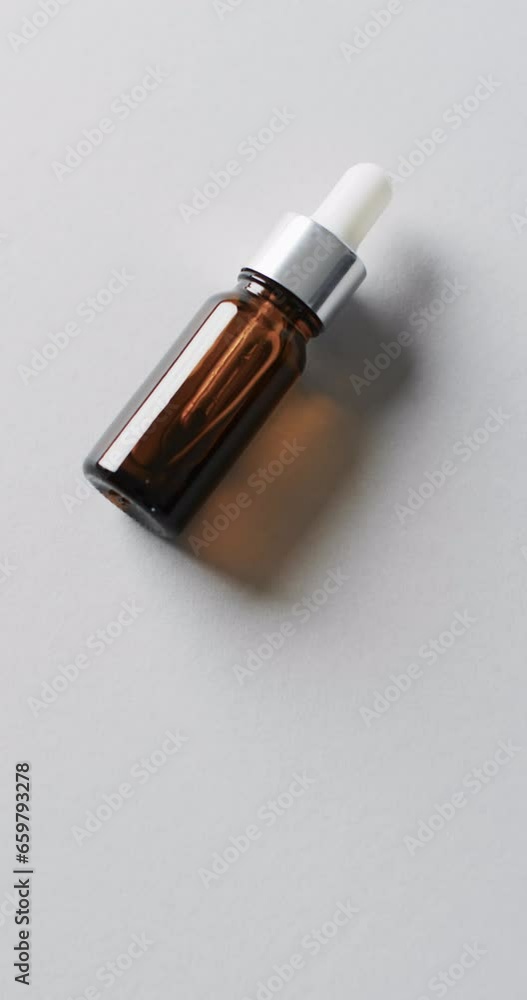 Vertical video of make up bottle with pipette and copy space on white background Vertical video of make up bottle with pipette and copy space on white background