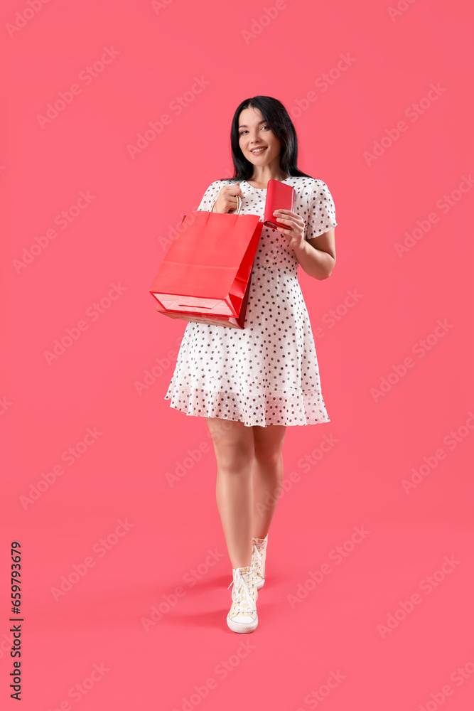 Portrait of beautiful young woman with shopping bag and purse on red background Portrait of beautiful young woman with shopping bag and purse on red background
