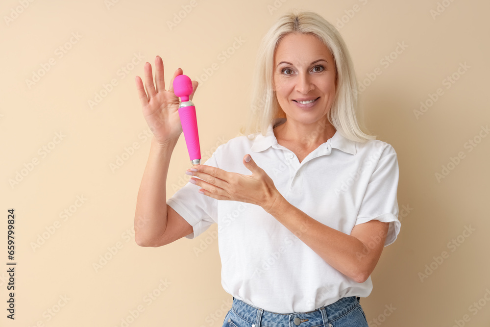 Mature woman with vibrator on beige background Mature woman with vibrator on beige background