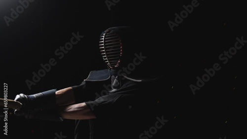 Man Adorned In Kendogu Swinging His Shinai photo