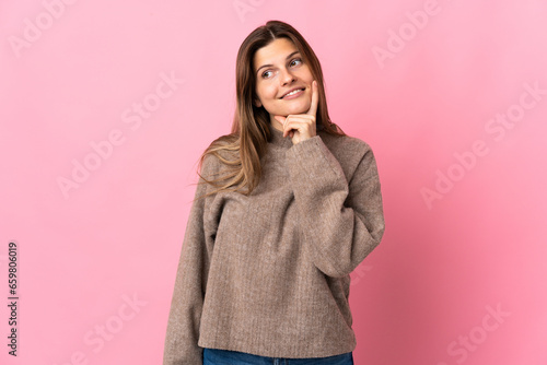 Young slovak woman isolated on pink background thinking an idea while looking up