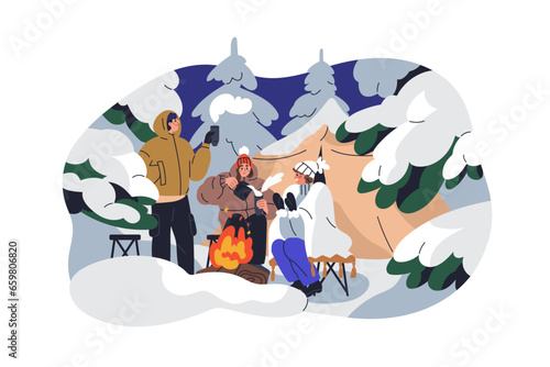 Winter camping in forest. People warming with hot tea at campfire outdoor. Fr...