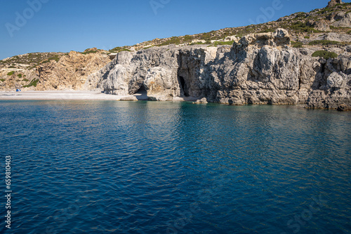 Stunning Beach and Rock Formations of Rhodes: A sea-level panoramic view of the island's diverse coastline, showcasing sandy retreats and towering cliffs, epitomizing Grecian beauty.